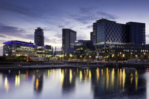 A shot of Media City across the River Irwell in the evening in Salford Quays, Manchester, featuring BBC and ITV buildings. 