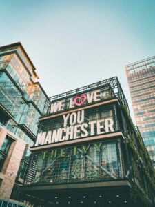 A photo of the side of The Ivy restaurant in Spinningfields, Manchester, with a message saying 'We Love You Manchester'. 